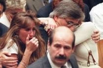 Fred Goldman, father of Ron Goldman, hugs his wife Patti, as his daughter, Kim, left, reacts du ...