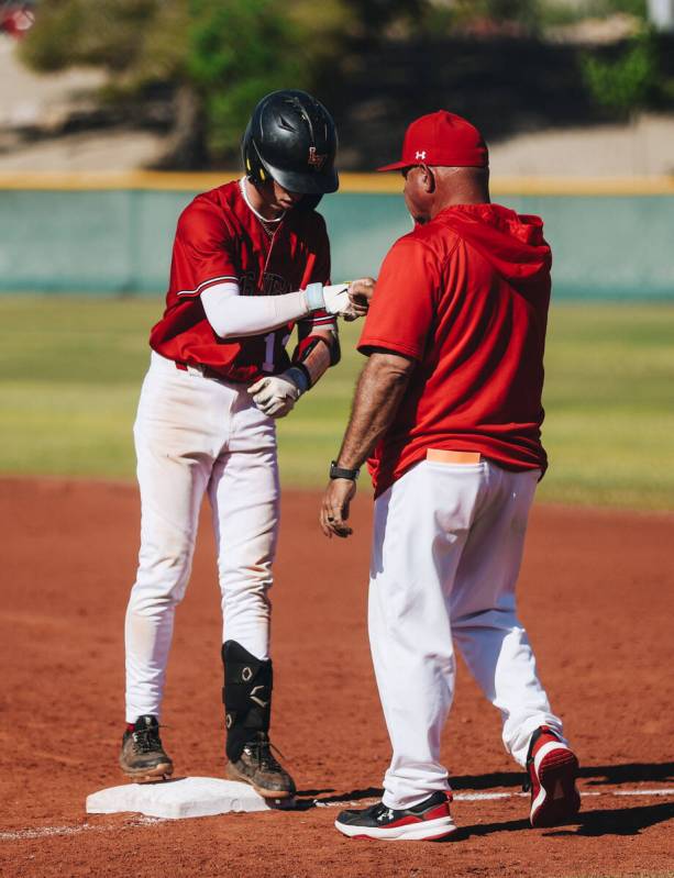 Las Vegas’ Kyle Iverson (13) fist bumps a Las Vegas coach during a baseball game between ...