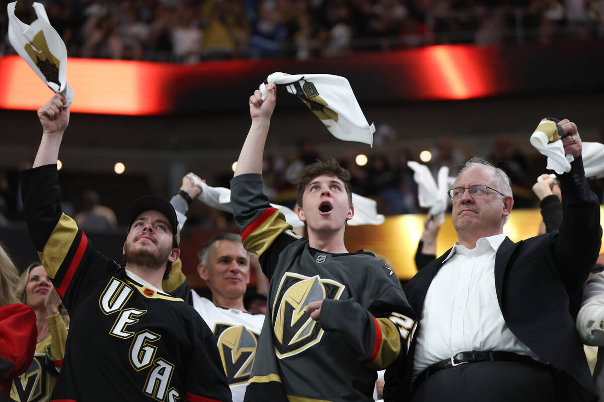 Golden Knights fans celebrate a goal during the first period of an NHL hockey game against the ...