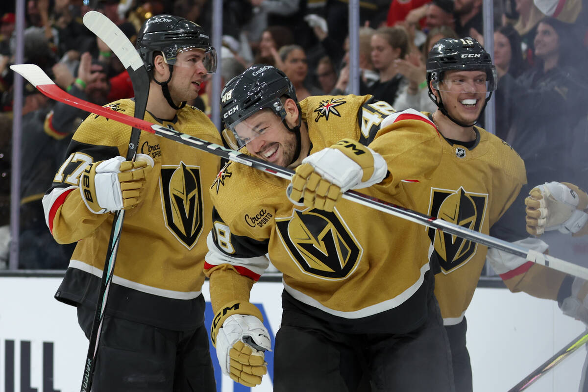 Golden Knights defenseman Ben Hutton, left and left wing Pavel Dorofeyev, right, congratulate c ...