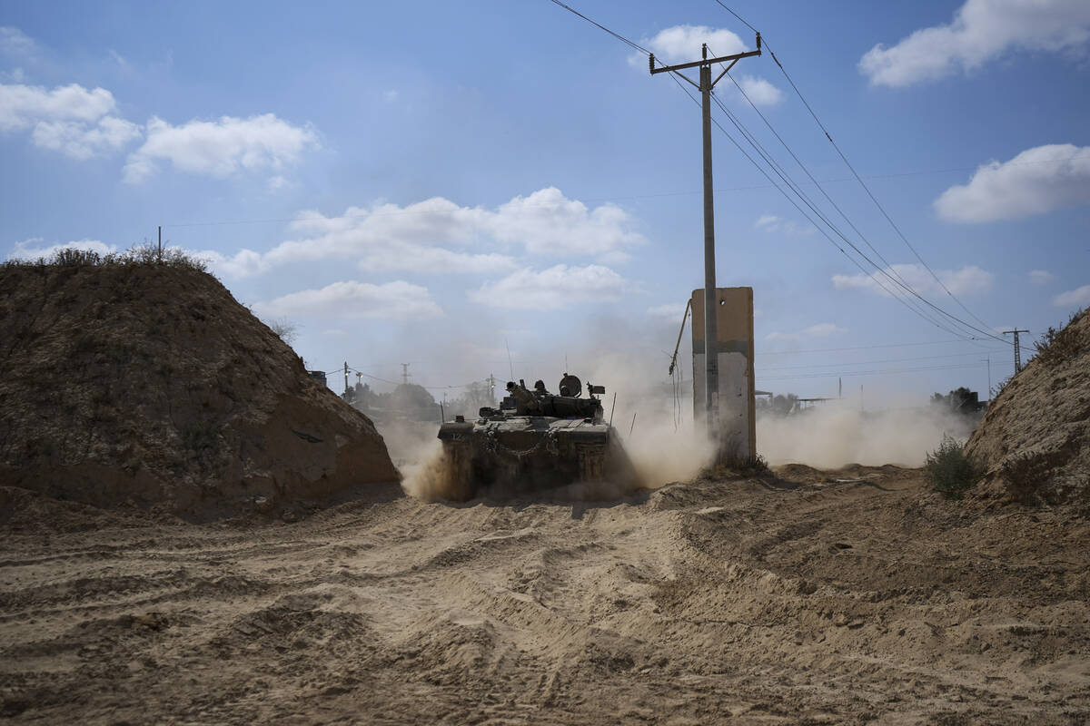 An Israeli tank moves near the Gaza Strip border in southern Israel, Thursday, April 11, 2024. ...