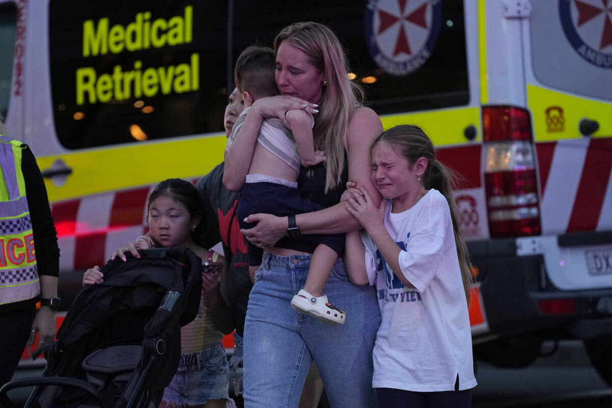 People are led out from the Westfield Shopping Centre where multiple people were stabbed in Syd ...