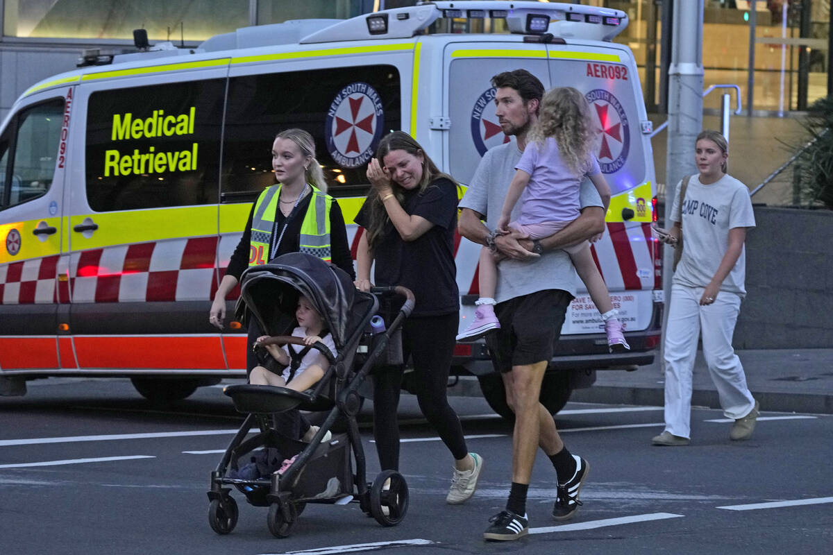 People are led out from the Westfield Shopping Centre where multiple people were stabbed in Syd ...