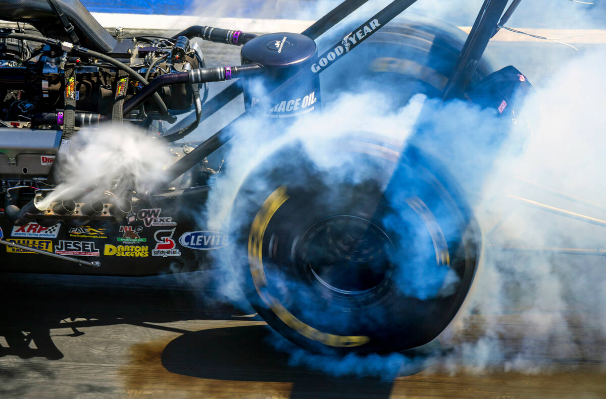 A dragster does a burnout to warm the tires during Day 2 of NHRA 4-Wide Nationals on "The ...