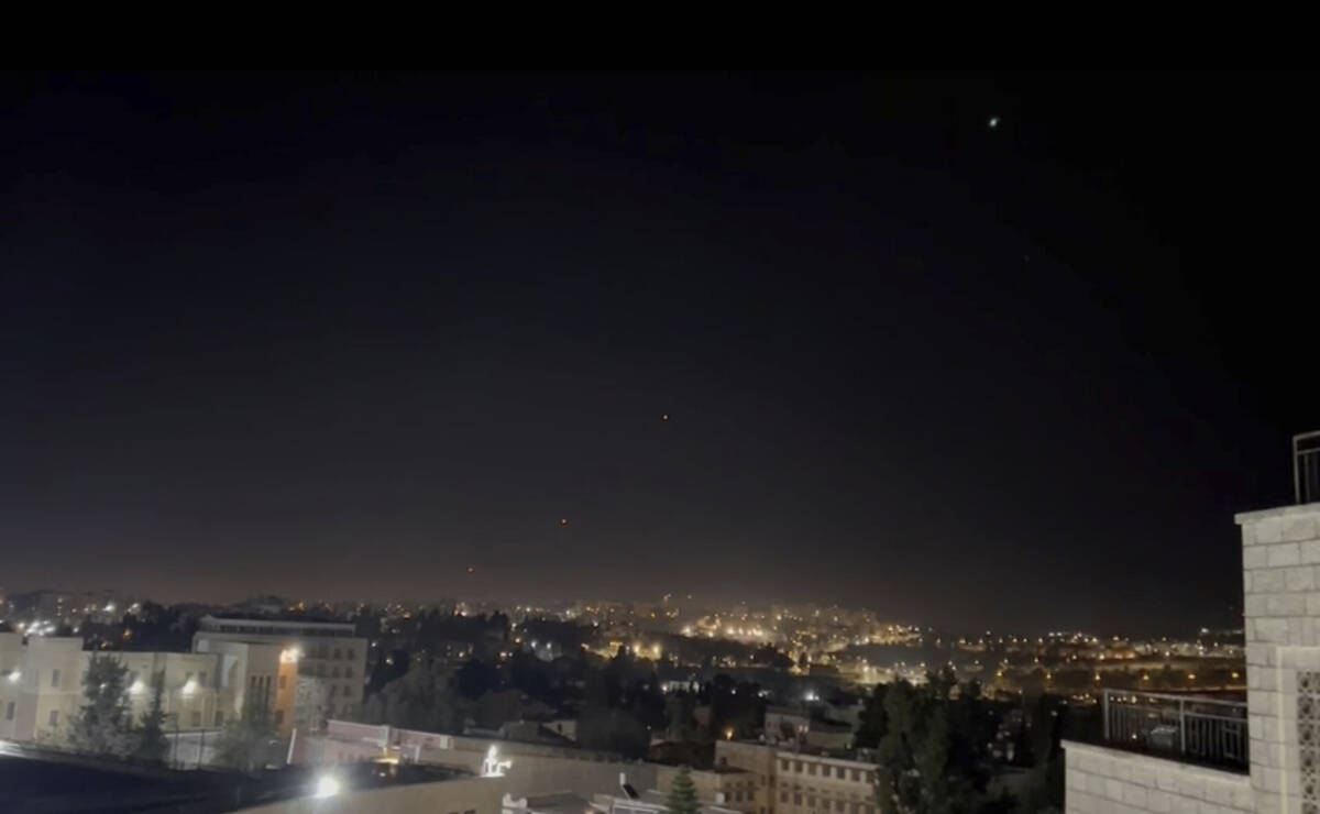 Interceptors missiles are launched into the sky early Sunday, April 14, 2024, in Jerusalem. (AP ...