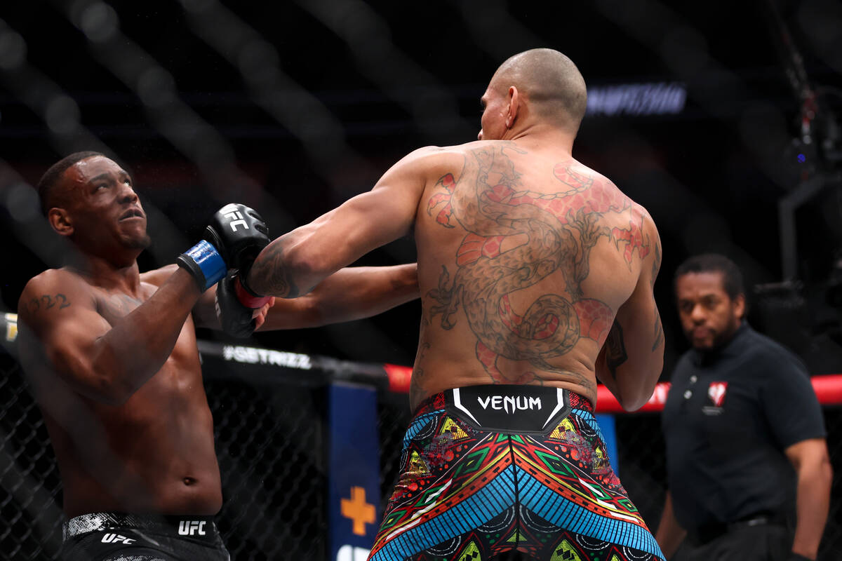 Alex Pereira pulls back while Jamahal Hill falls to the mat before he is knocked out during the ...