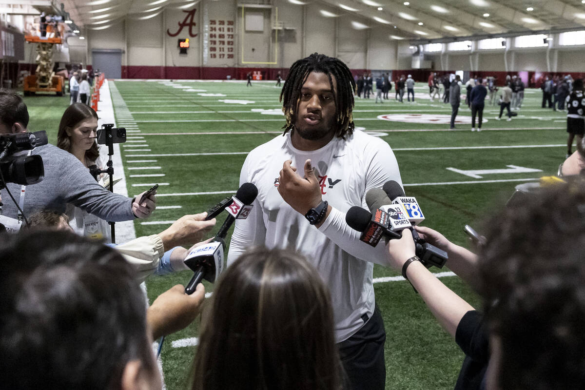 Former Alabama offensive lineman JC Latham talks with the media at Alabama's NFL football pro d ...