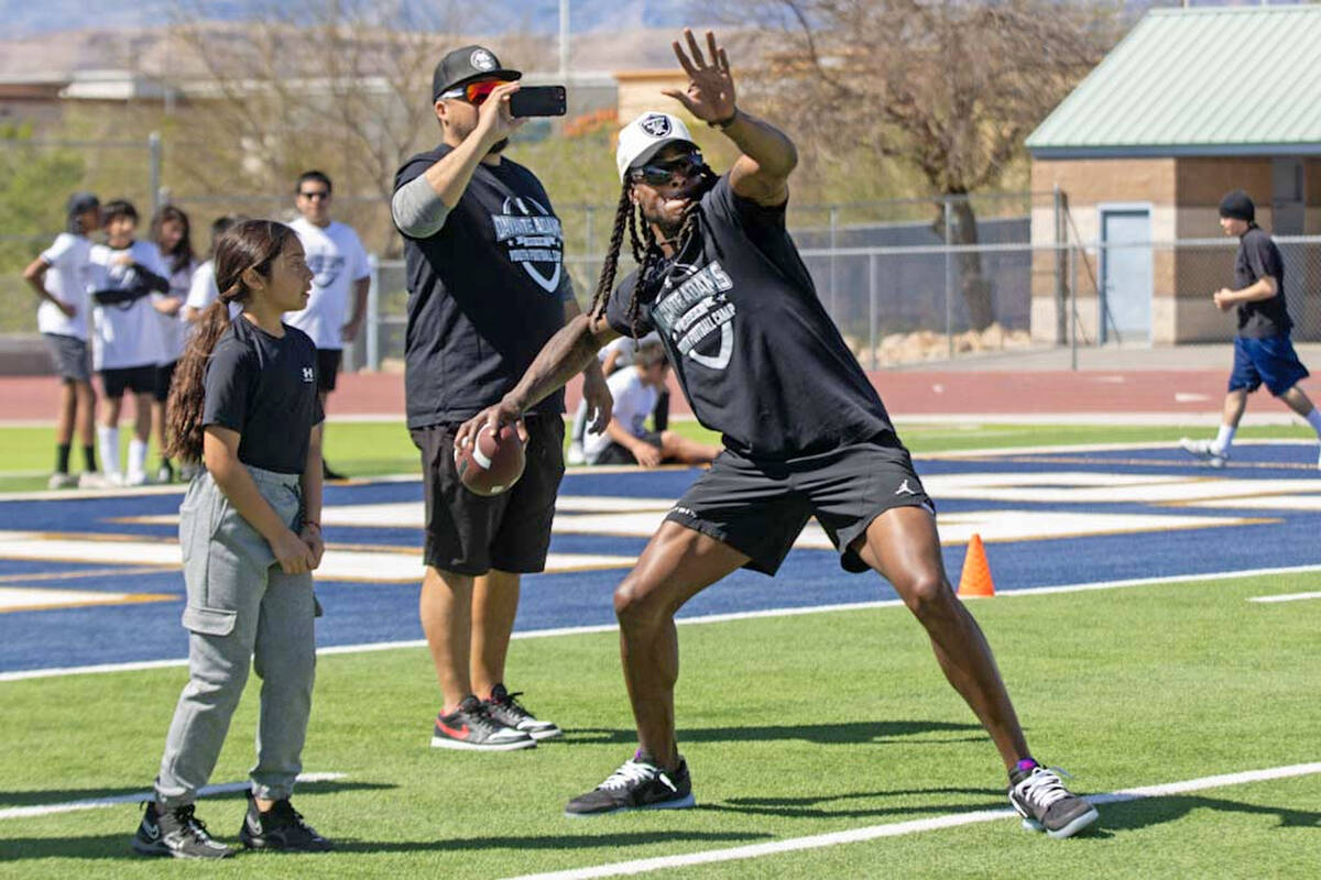 Raiders wide receiver Davante Adams throws deep during his youth camp on Sunday, April 14, 202 ...