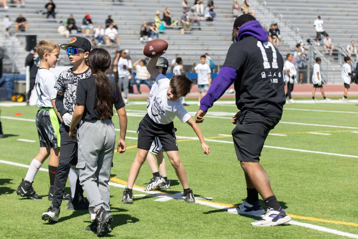 A participant of the Davante Adams youth camp spikes a football on Sunday, April 14, 2024, at S ...