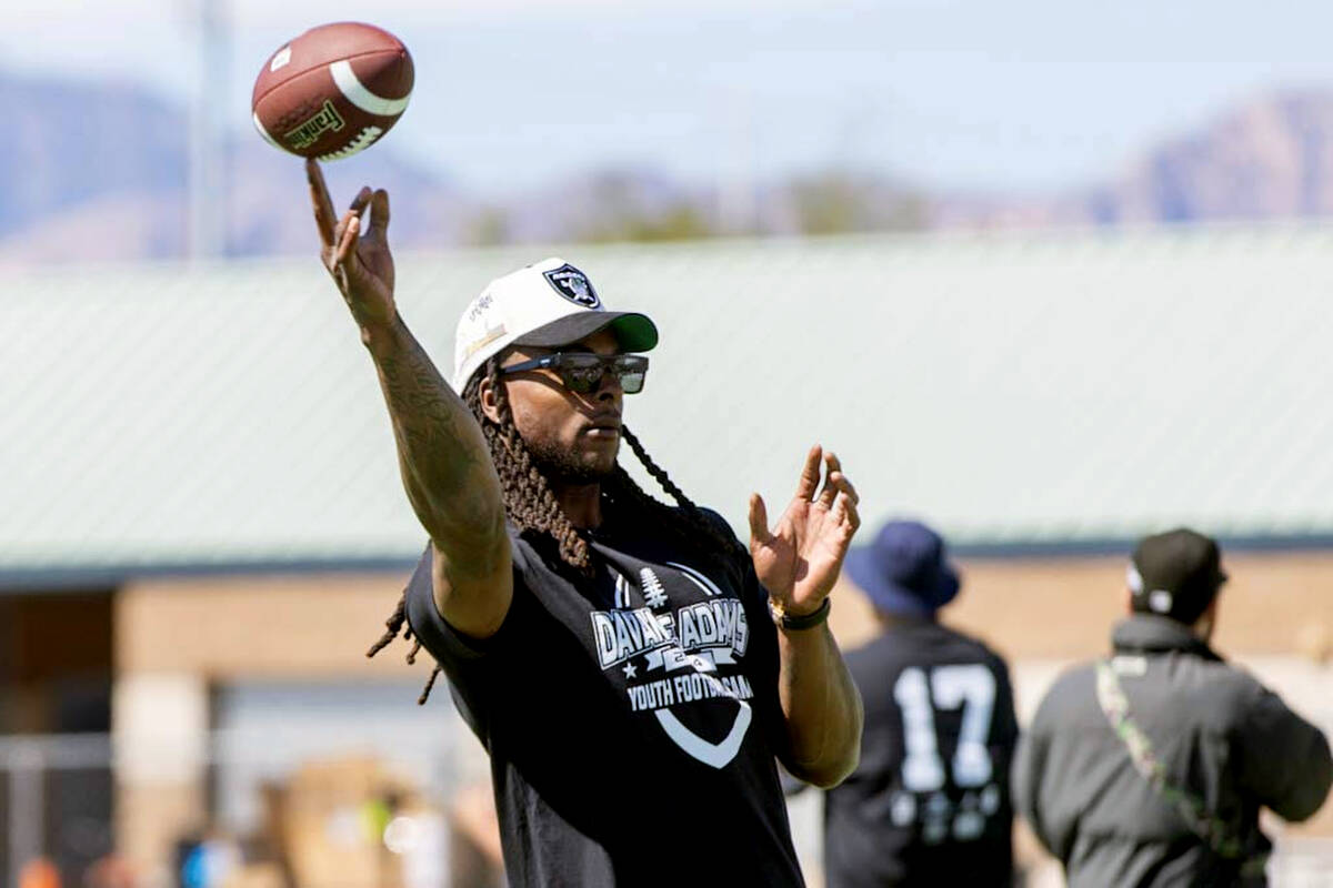 Raiders wide receiver Davante Adams throws the football to participants of his youth camp on Su ...