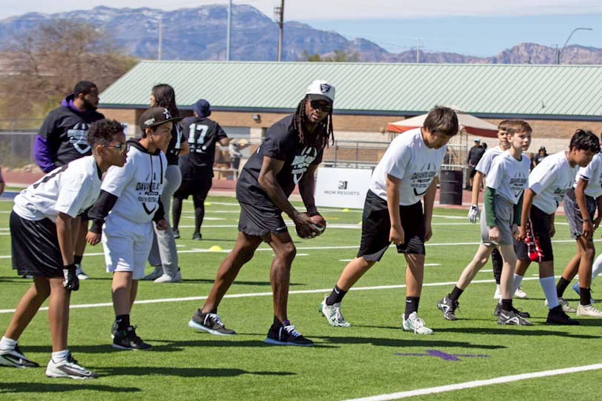 Raiders wide receiver Davante Adams lines up to run drills with participants of his youth camp ...