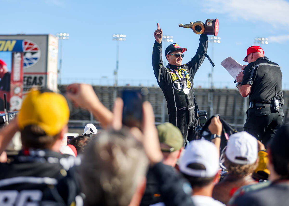 Funny car driver Bob Tasca cheers to the audience after winning the NHRA 4-Wide Nationals at th ...