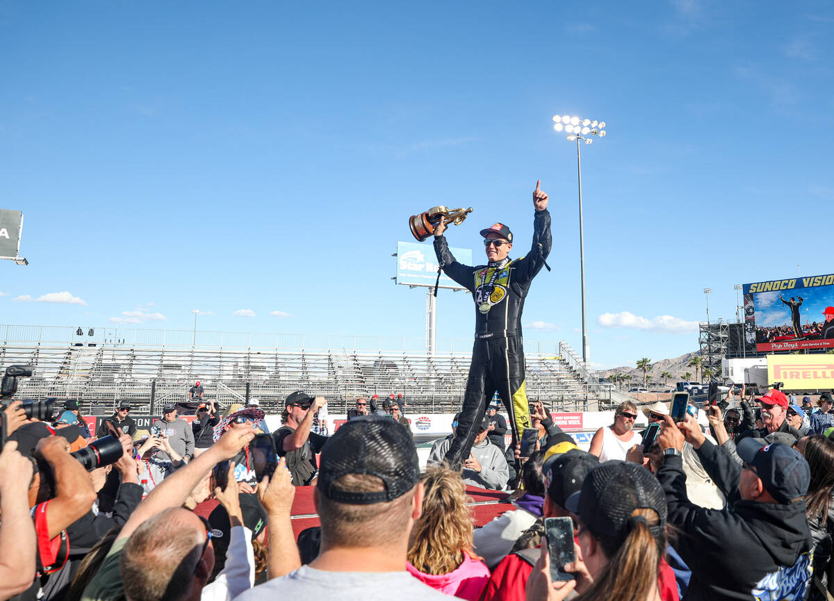 Funny car driver Bob Tosca gestures to fans following his win in the NHRA 4-Wide Nationals at t ...