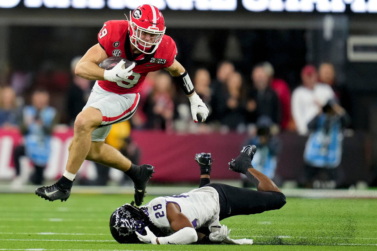 Georgia tight end Brock Bowers (19) leaps over TCU safety Millard Bradford (28) during the seco ...