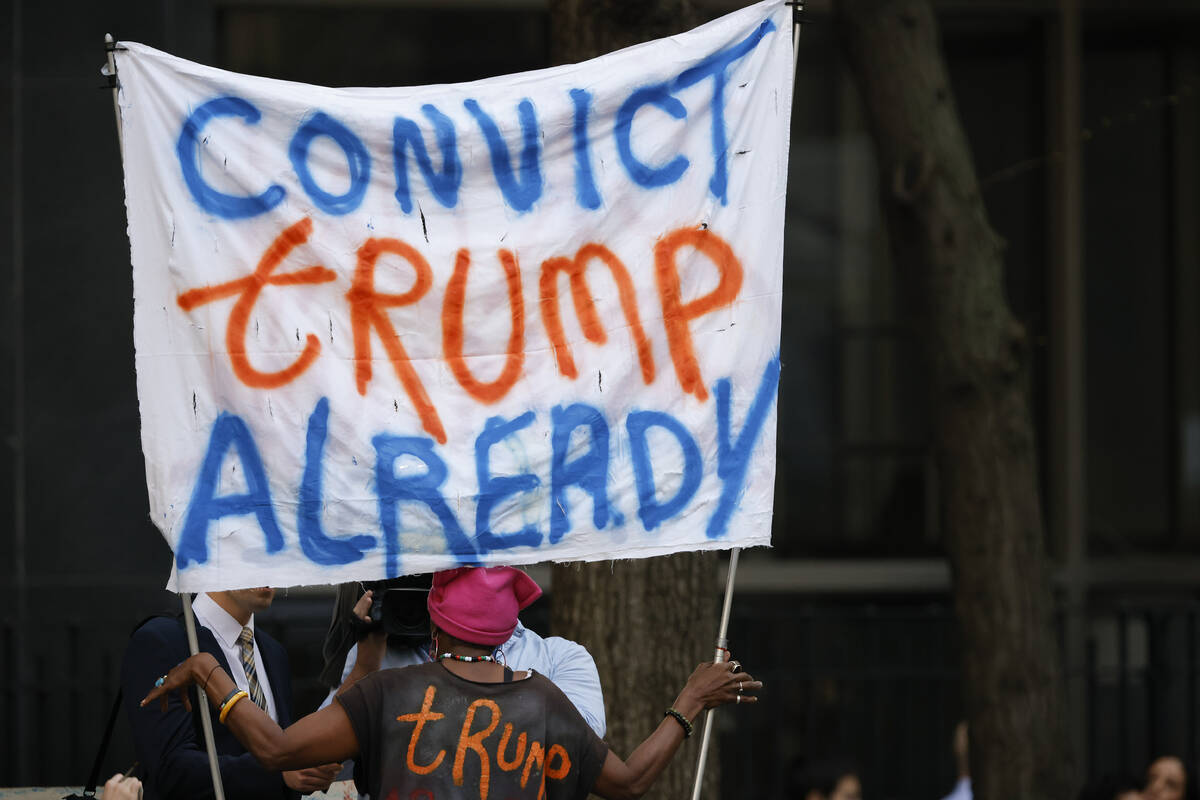 A protestor demonstrates outside Manhattan criminal court ahead of the start of jury selection ...