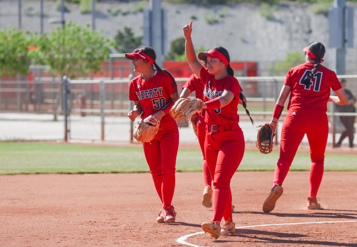 Liberty High School softball players get ready to play in a game against Centennial High School ...