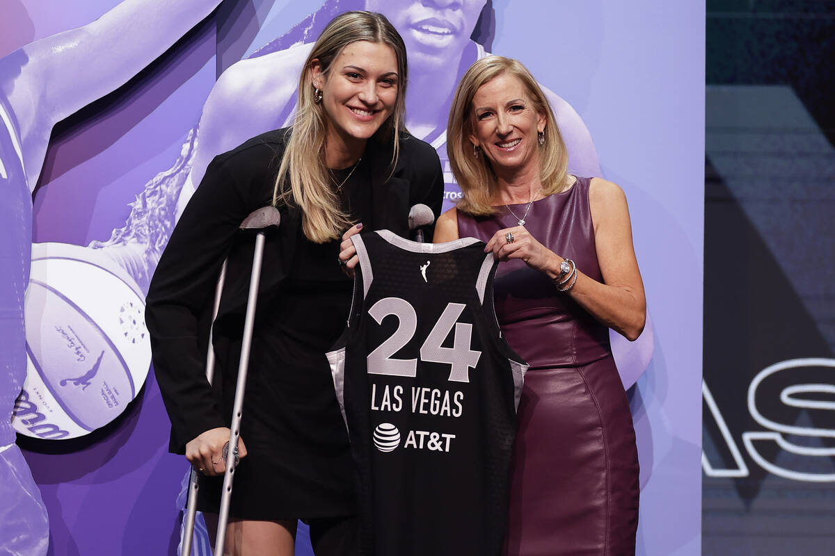 Virginia Tech's Elizabeth Kitley, left, poses for a photo with WNBA commissioner Cathy Engelber ...