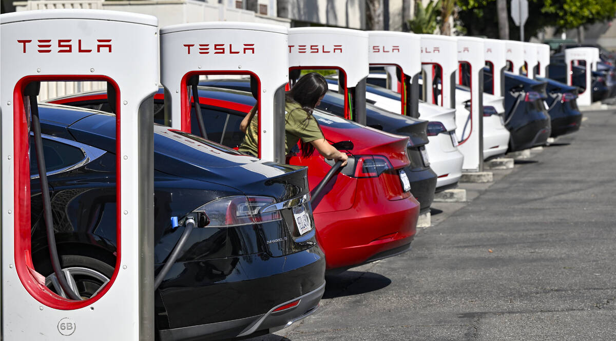 Drivers charge their Teslas in Santa Ana, Calif., on March 20, 2024. After reporting dismal fir ...