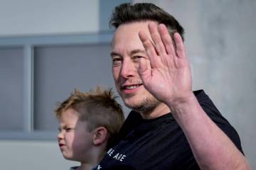 Tesla CEO Elon Musk waves as he leaves the Tesla Gigafactory for electric cars after a visit in ...