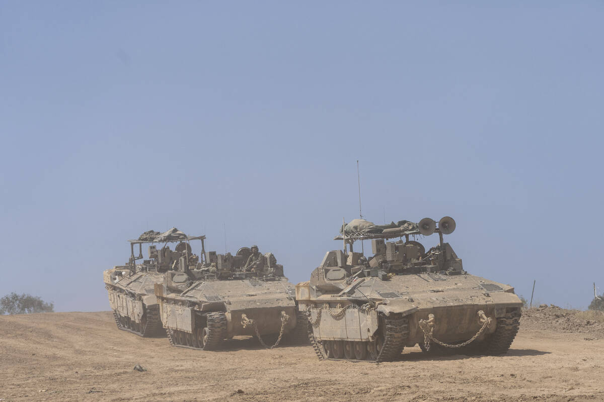 Israeli soldiers drive personnel carriers (APC) near the border with Gaza Strip, in southern Is ...