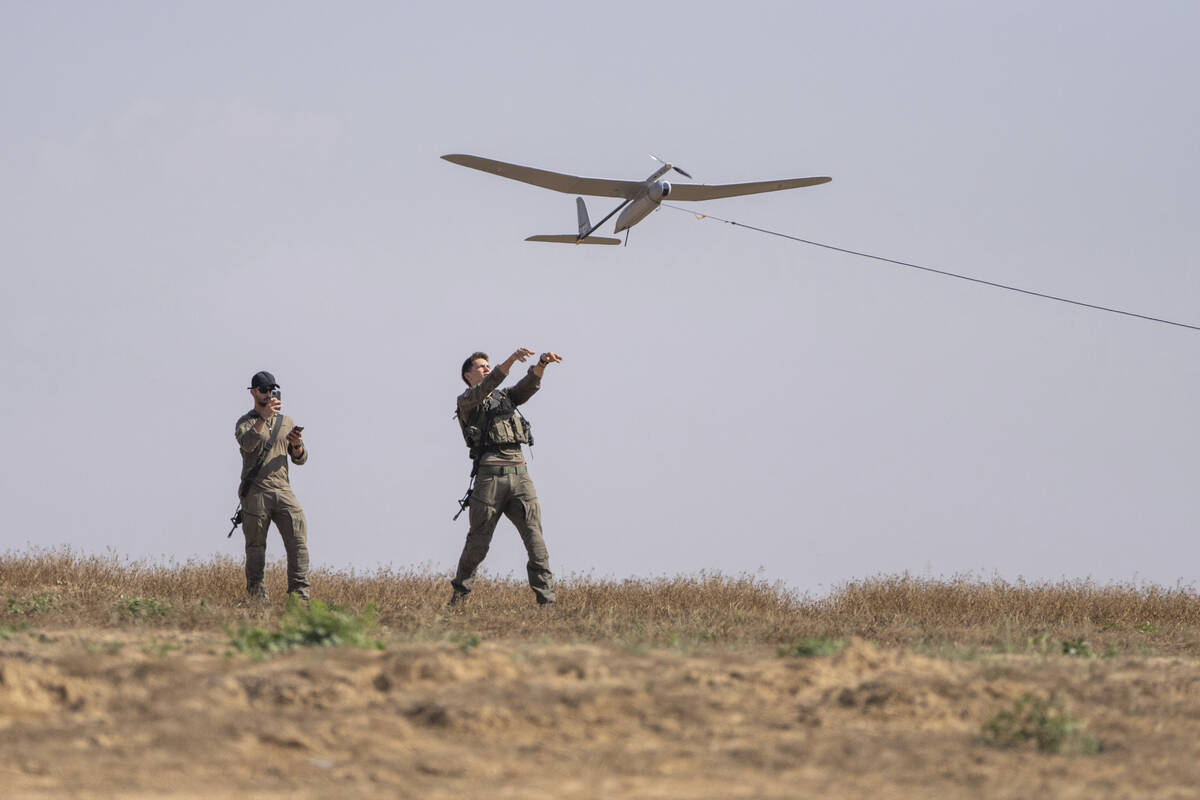 Israeli soldiers launch a drone near the Israeli-Gaza border, southern Israel, Monday, April 15 ...