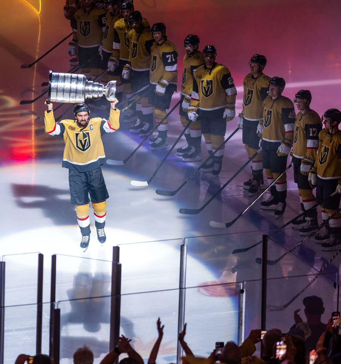 Golden Knights right wing Mark Stone (61) carries out the Stanley Cup during the raising of the ...