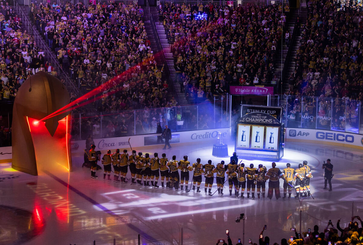 Golden Knights players gather during the raising of the 2023 Stanley Cup Championship banner be ...