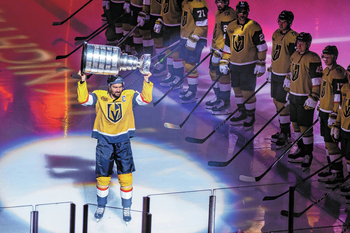 Golden Knights right wing Mark Stone (61) carries out the Stanley Cup during the raising of the ...