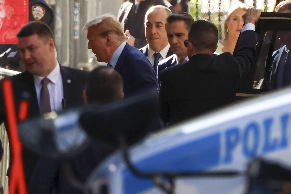 Former President Donald Trump, second from left, arrives at Manhattan criminal court, Tuesday, ...