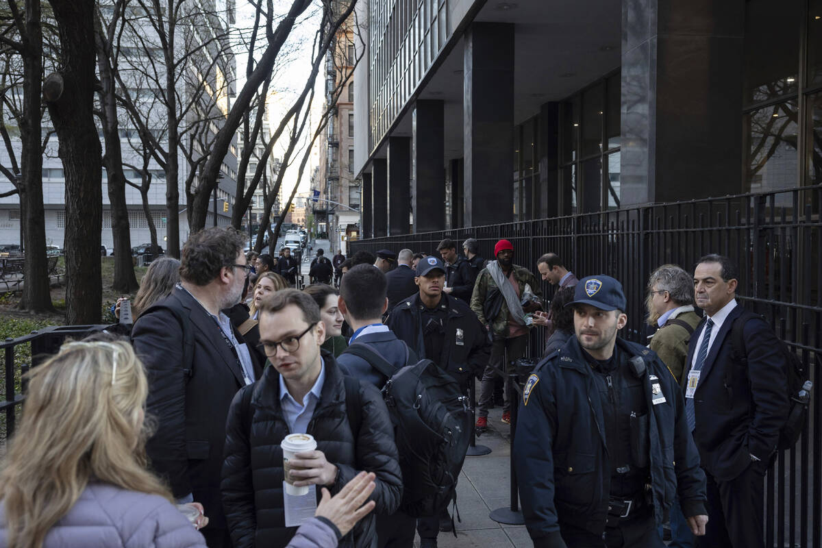 Members of the media gather outside Manhattan Criminal Court, Tuesday, April 16, 2024, in New Y ...