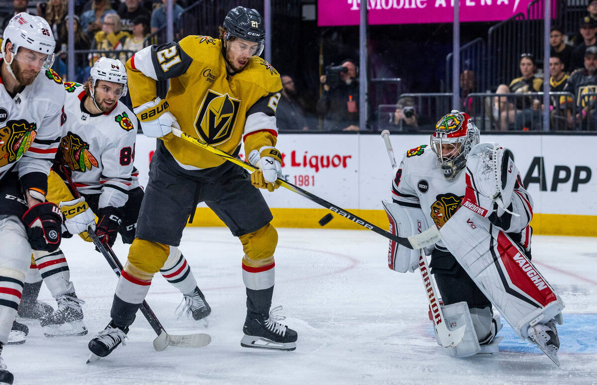 Golden Knights center Brett Howden (21) looks to deflect a puck past Chicago Blackhawks goalten ...