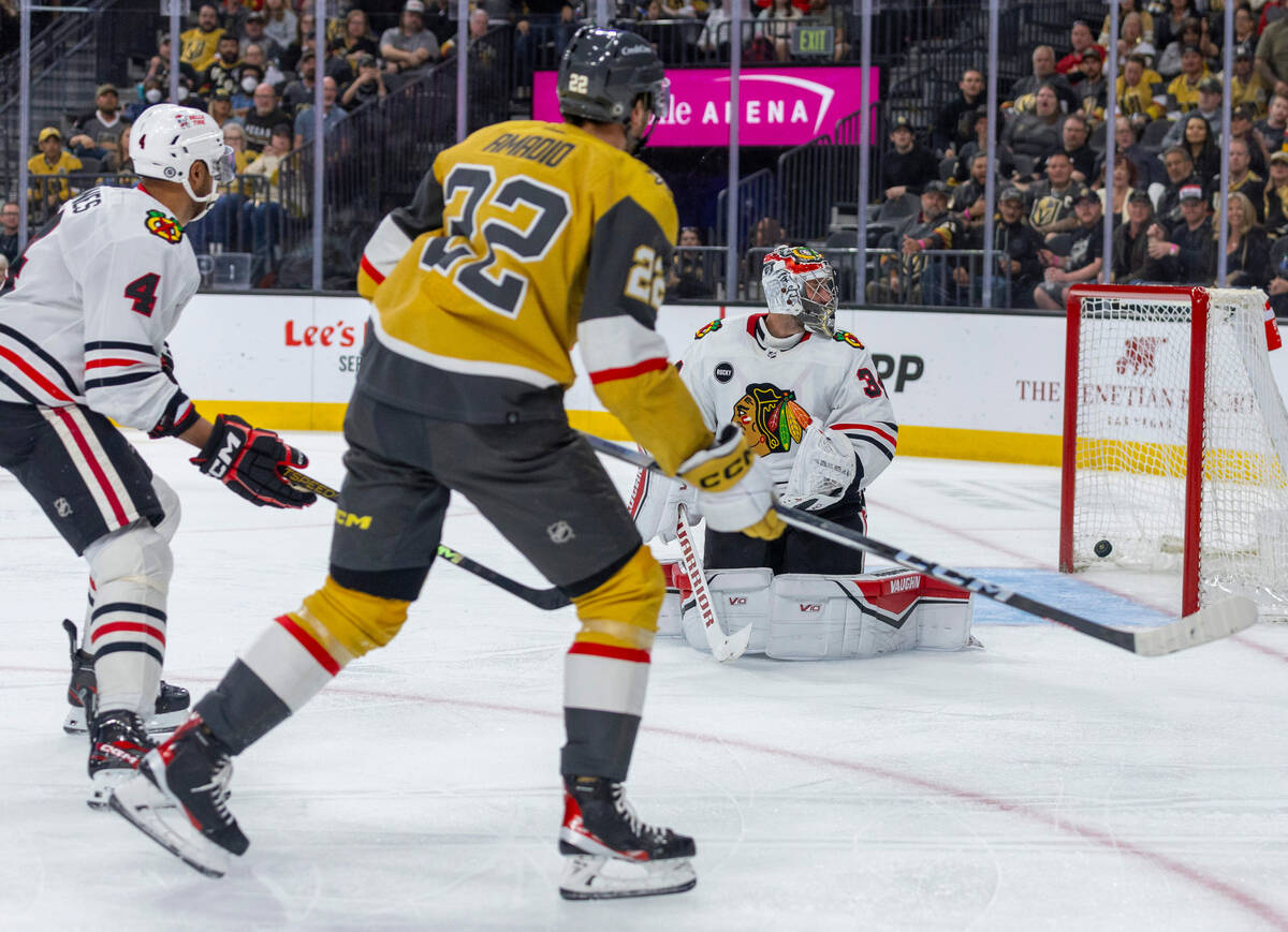 Golden Knights right wing Michael Amadio (22) scores on Chicago Blackhawks goaltender Petr Mraz ...