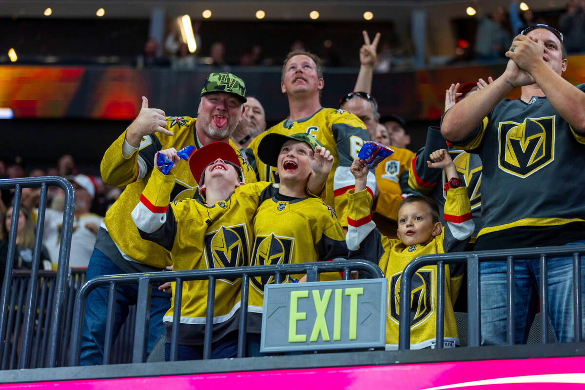 Golden Knights fans celebrate a score on Chicago Blackhawks goaltender Petr Mrazek (34) during ...