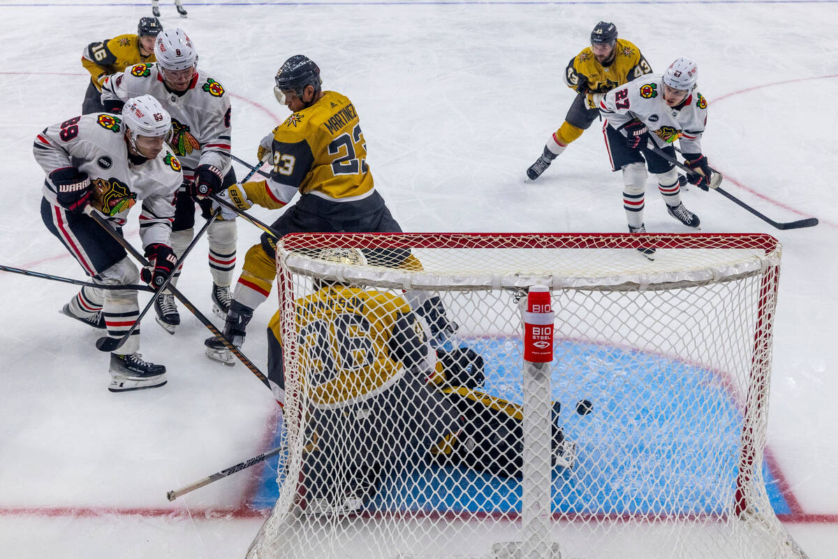 Golden Knights goaltender Logan Thompson (36) deflects a shot away from the net by Chicago Blac ...