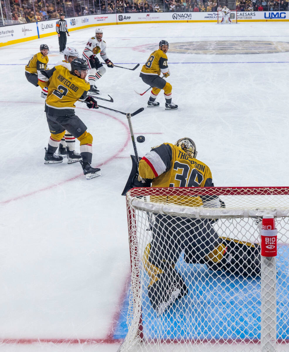 Golden Knights goaltender Logan Thompson (36) deflects a shot away from the net by the Chicago ...
