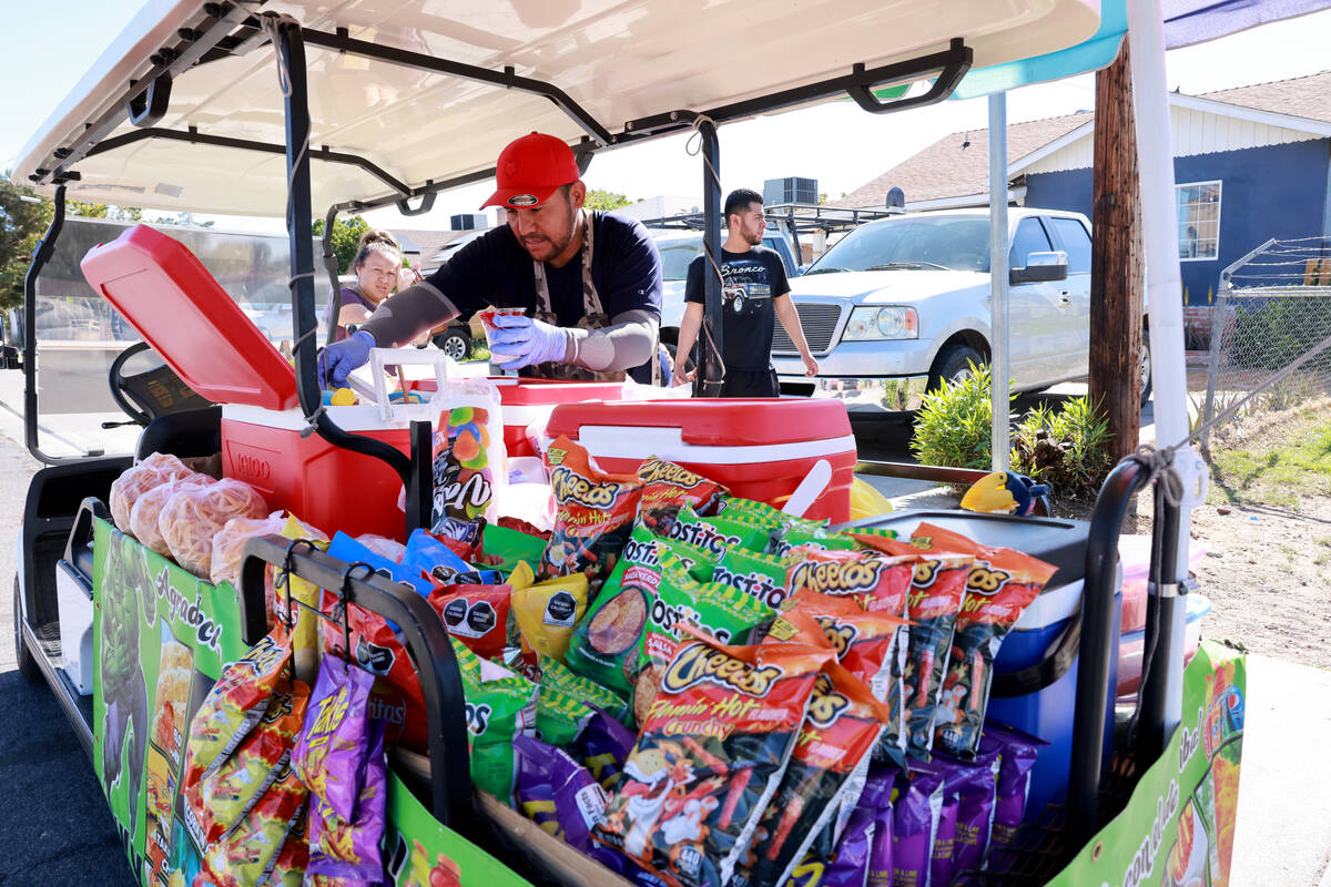 Sidewalk vendor Oracio Gonzalez Moreno makes a customer’s order in Las Vegas Tuesday, Ap ...