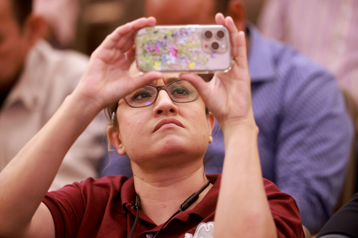 Audience members listen during a public hearing on a sidewalk vendor licensing ordinance at the ...