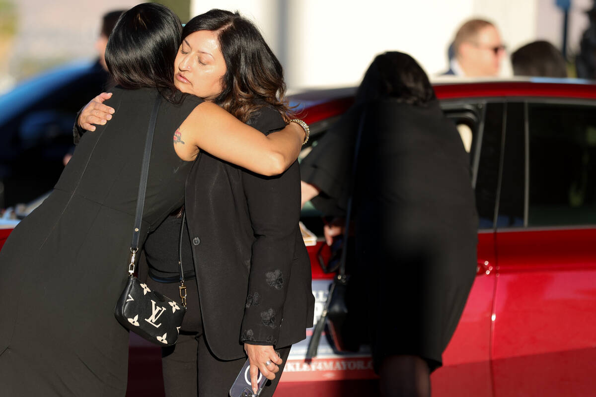 Loved ones of Dennis Prince, 57, embrace after the Las Vegas attorney’s funeral outside Palm ...