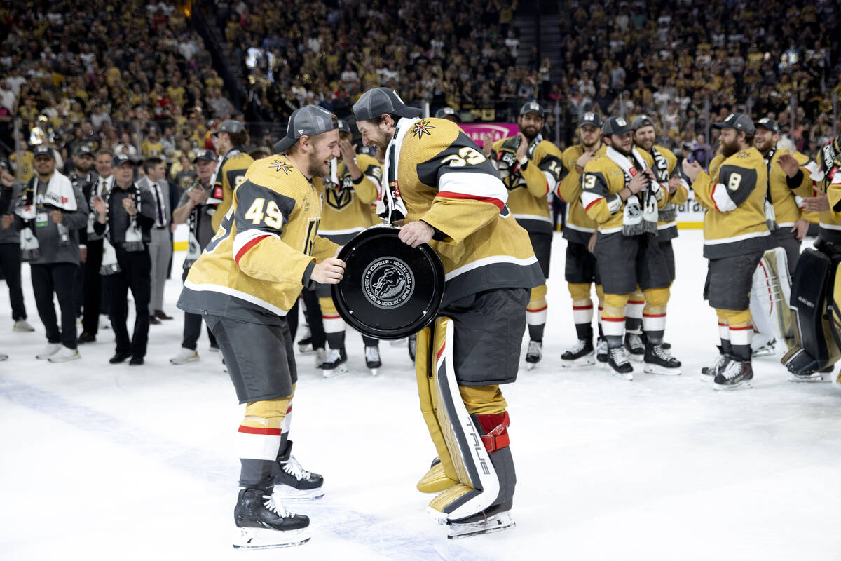 Golden Knights center Ivan Barbashev (49) hands the Stanley Cup off to goaltender Adin Hill (33 ...