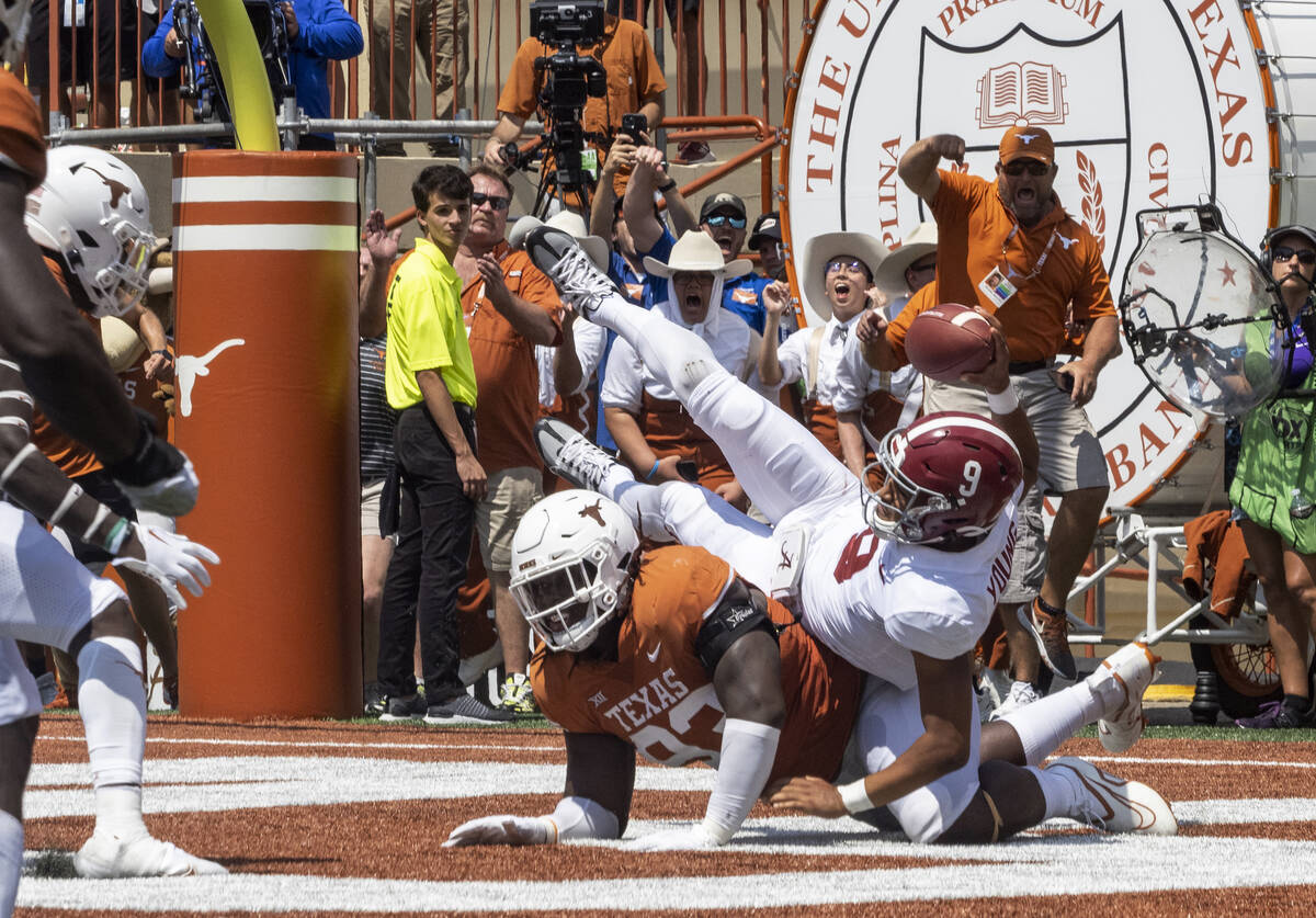 Texas defensive edge rusher T'Vondre Sweat knocks down Alabama quarterback Bryce Young (9) in t ...