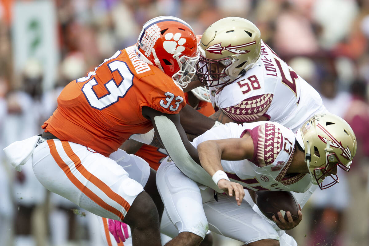 Clemson defensive tackle Ruke Orhorhoro (33) sacks Florida State quarterback Jordan Travis (13) ...