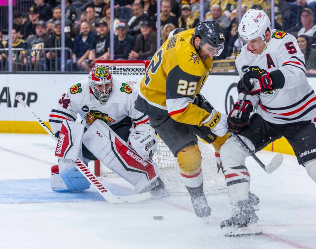 Golden Knights right wing Michael Amadio (22) battles for the puck against Chicago Blackhawks d ...