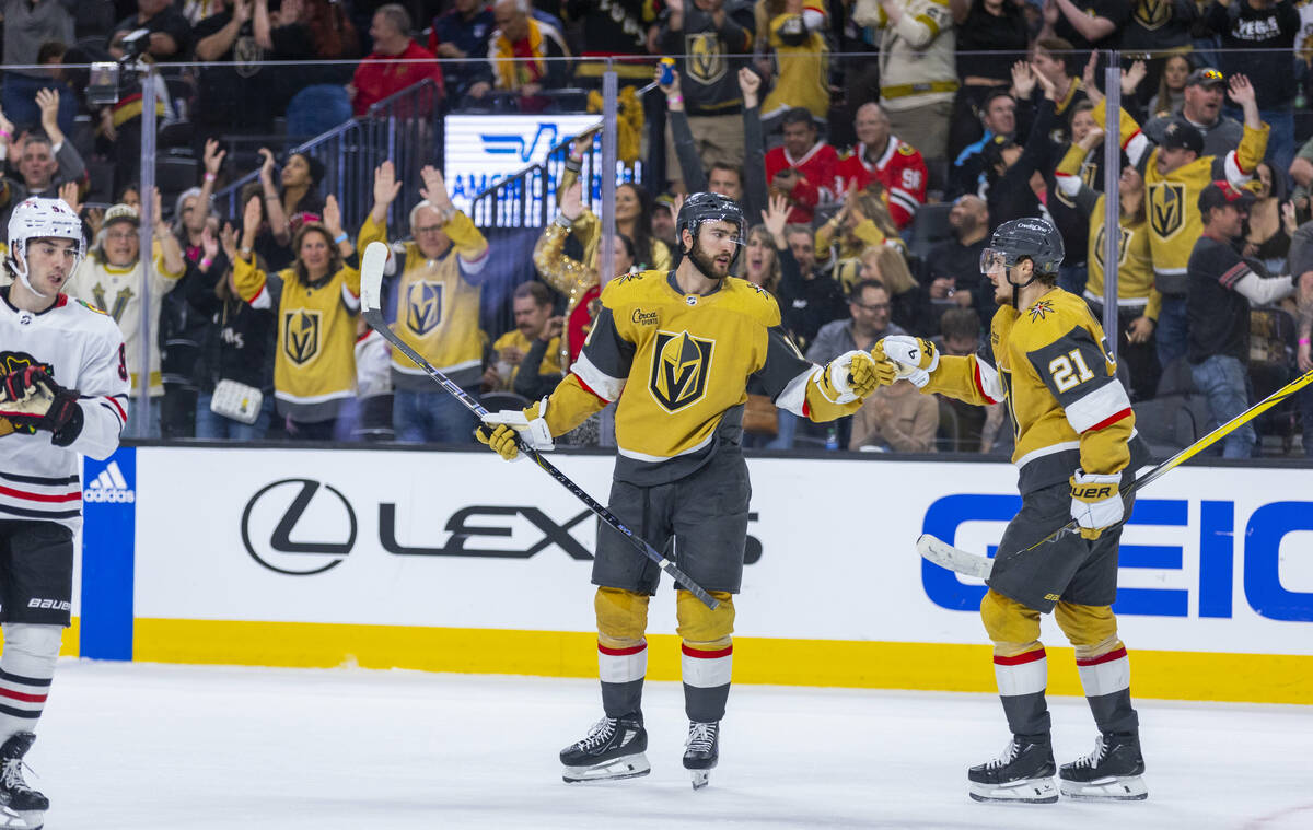 Golden Knights center Nicolas Roy (10) and center Brett Howden (21) celebrate the third goal of ...