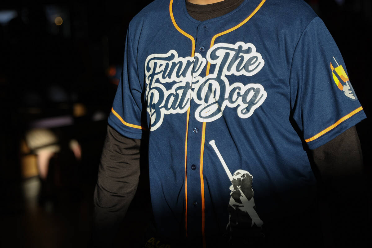 A fan wears a Finn the Bat Dog jerseys to honor the Las Vegas Aviators’ long-time bat re ...