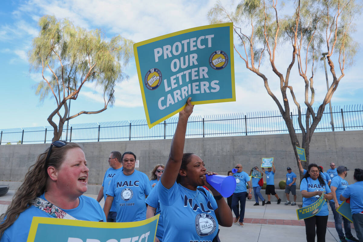 Postal workers protest during a National Association of Letter Carriers rally outside the Lloyd ...