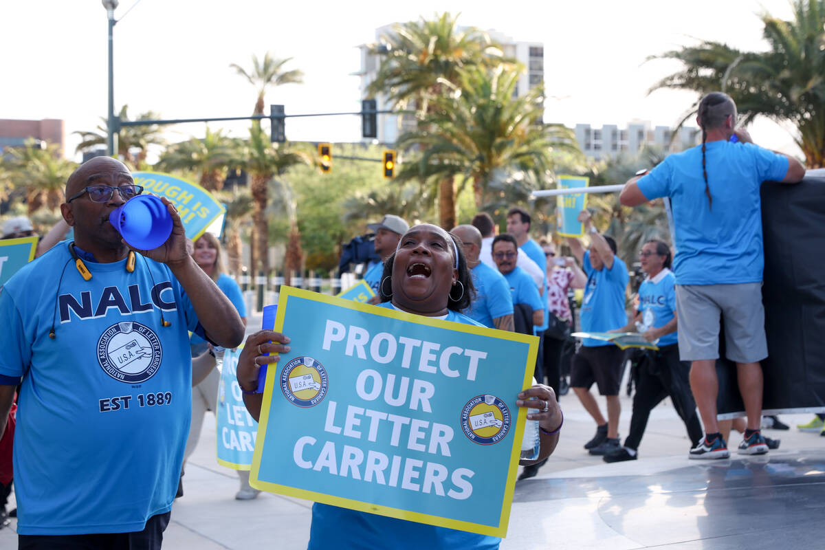 Postal workers protest during a National Association of Letter Carriers rally outside the Lloyd ...