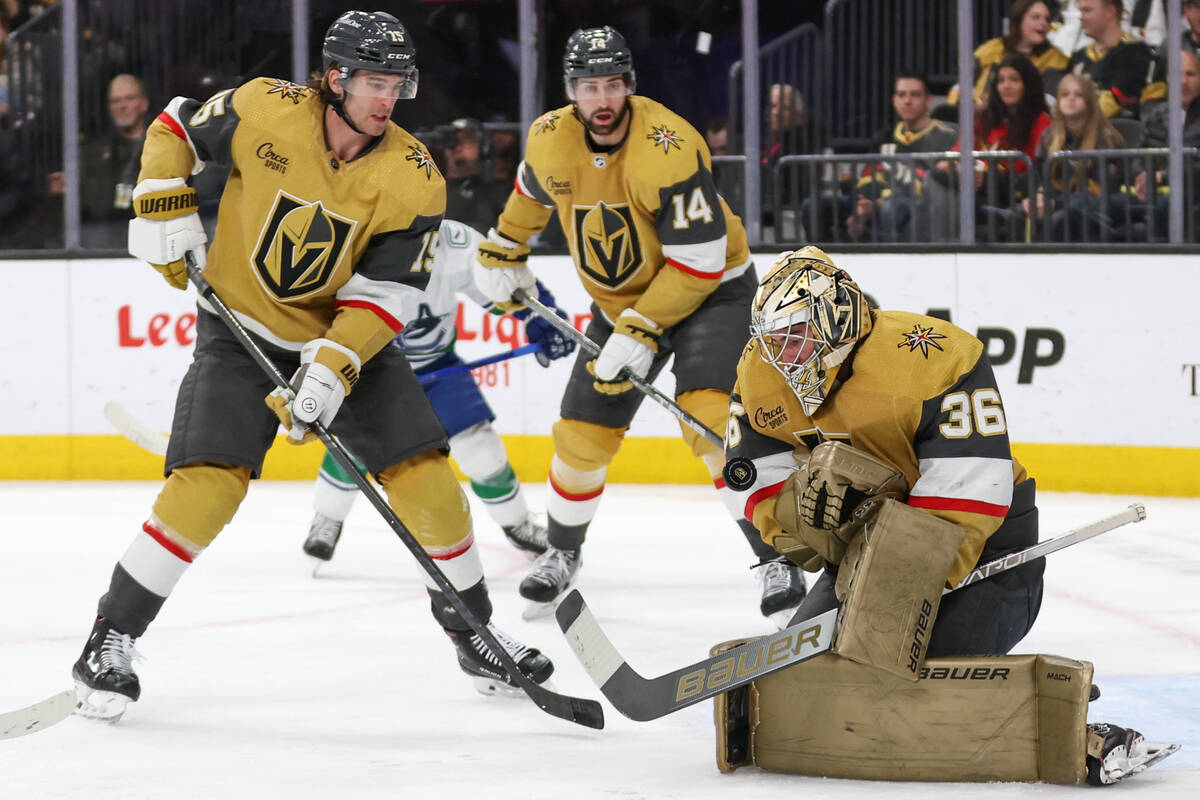 Golden Knights goaltender Logan Thompson (36) saves the puck while Golden Knights defensemen No ...