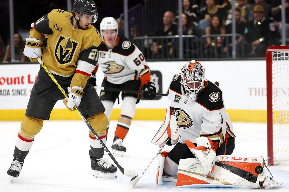 Ducks goaltender Lukas Dostal (1) saves the puck after Golden Knights center Brett Howden (21) ...