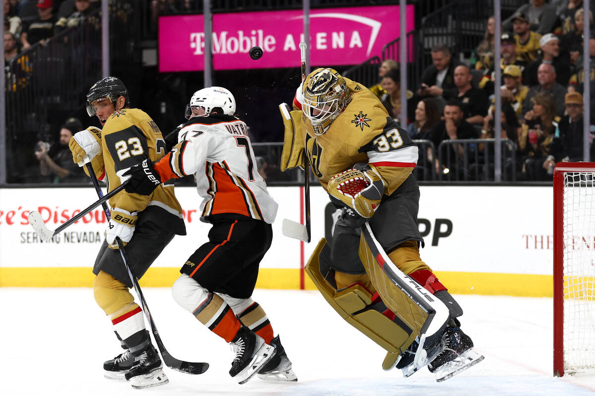 Golden Knights goaltender Adin Hill (33) jumps to make a save with his helmet while Knights def ...