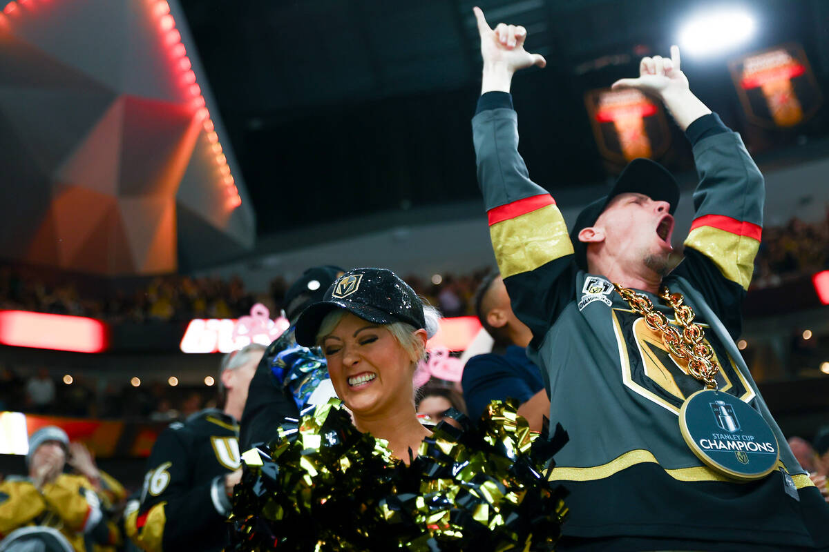 Golden Knights fans celebrate a goal during the second period of an NHL hockey game against the ...
